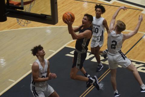 Jadon Yeh finshes off a drive to the basket during the first quarter of the Warriors' win over West Hall Tuesday night in Oakwood. Yeh tied Silas Mulligan for scoring honors with 16 points. (Photos/Mark Turner)
