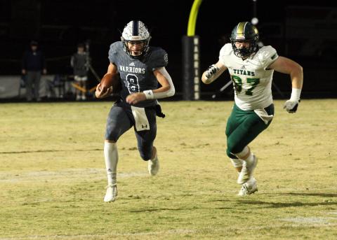 WCHS quarterback J. Ben Haynes runs away from Blessed Trinity's Grayson Gilder during the regular season finale in November.Haynes was a 7-AAAA All-region pick this season after leading the region in passing yardage and total touchdowns. (Photo/Staci Sulhoff)