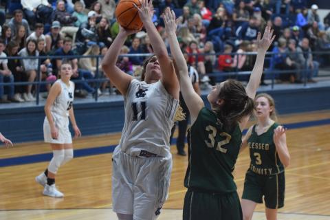 Maddie Futch scores over Blessed Trinity's Erin Hynekamp during the Lady Warriors' region win Tuesday night in Cleveland. (Photo/Mark Turner)