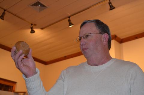 Charlie Thomas holds up a game stone that he presented at the show and tell program at the White County Historical Society meeting last week. More photos from the event are in this week's White County News. (Photo/Stephanie Hill)
