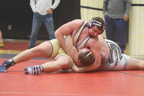 White County's Devin Sullens pins Flowery Branch's Clayton Walczuk to win the Region 7-AAAA championship match in the 285-pound division. Sullens had a pair of pins during the region tournament last Saturday at Flowery Branch High School, and earned a spot in the Class AAAA sectionals this weekend in Perry. (Photo/Mark Turner)