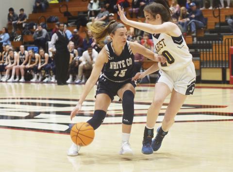White County's Ellie Gearing, left, tries to dribble past Marist's Maggie Thayer during the opening quarter of the Region 7-AAAA title game Monday night in Flowery Branch. (Photo/Mark Turner)