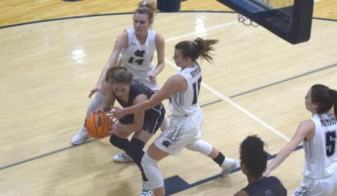 Naomi Crumley, left, and Ellie Gearing put some defensive pressure on West Hall's Amber Hughes during the tournament opener Tuesday night in Cleveland. (Photos/Mark Turner)