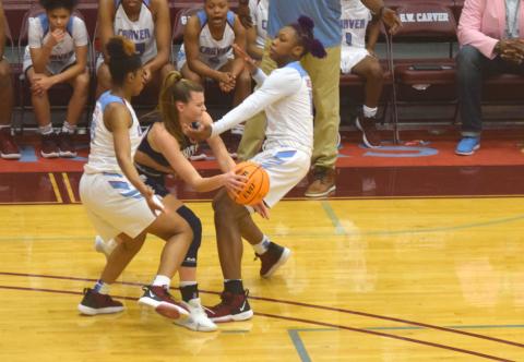 Ellie Gearing tries to make a pass out of a double-team during the Class AAAA playoff game last week in Columbus. (Photos/Mark Turner)