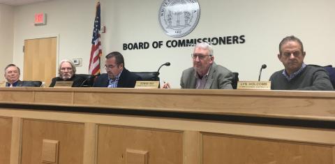 White County Board of Commissioners Chairman Travis Turner (middle) reads aloud the proclamation as fellow commissioners listen, from left Craig Bryant, Edwin Nix and Lyn Holcomb. (Photo/Wayne Hardy)