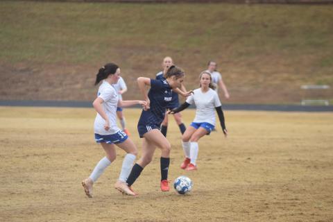 Chloe Shea slips by a Banks County defender during the Lady Warriors 10-1 win. (Photos/Mark Turner)