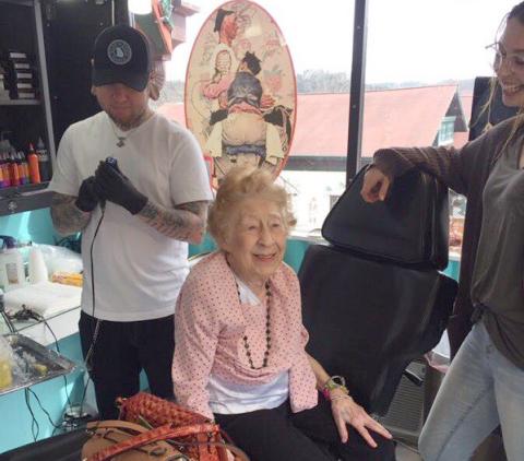 Tattoo artist Mark Ayers prepares to place a design  on 100-year-old Araminta “Mitzi” Bythewood of Cleveland. (Photo courtesy Ashlyn Turner)