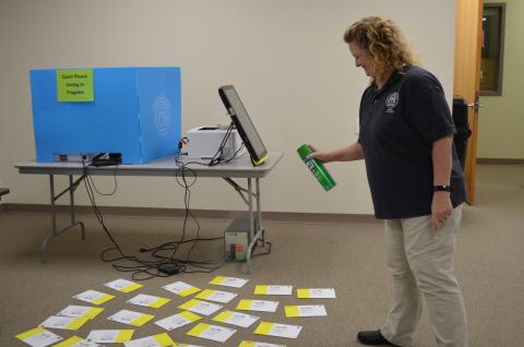 White County Chief Voter Registrar Lisa Manning said almost 1,500 absentee ballots had been completed and returned by voters as of May 11. She is shown sanitizing some of them as part of the office’s COVID-19 precautions. (Photo/Stephanie Hill)