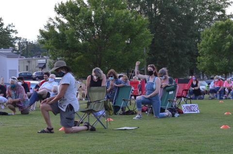 Kelsey Wolff of Gainesville raises her fist as Devin Pandy asked everybody to take a knee for a moment of prayer during the rally for unity in Cleveland’s Freedom Park on June 3. (Photo/Stephanie Hill)
