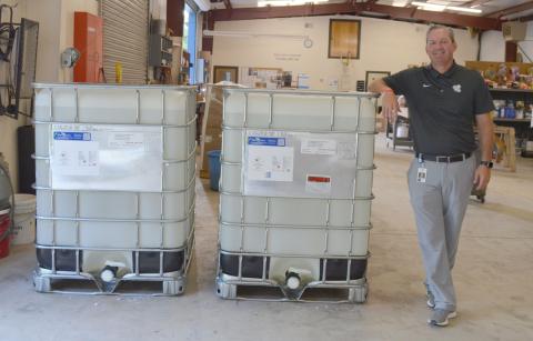 White County School System Assistant Superintendent Scott Justus shows off the 640 gallons of hand sanitizer the school system purchased for this year. (Photo/Stephanie Hill)