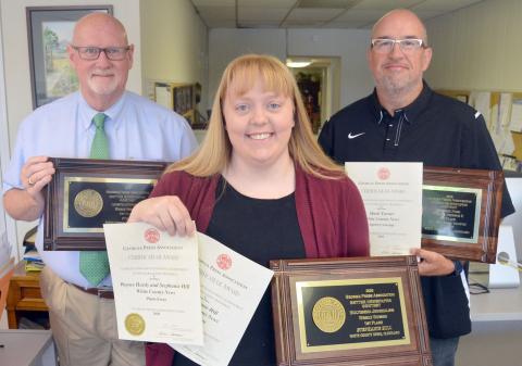 From left, White County News marketing specialist Tom Tucker, reporter Stephanie Hill and Sports Editor Mark Turner hold some of the newspaper’s recent awards from the Georgia Press Association Better Newspaper Contest.