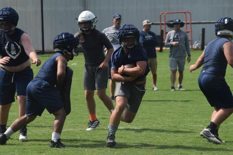 Riley Stancil heads up the field during Tuesday's workout at the WCHS football facility. (Photo/Mark Turner)