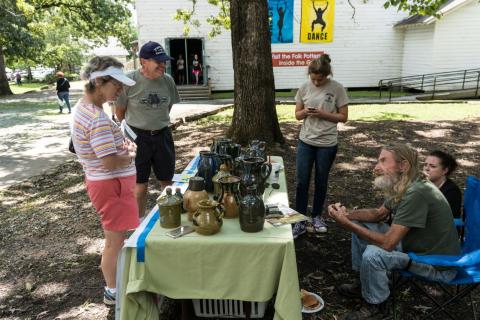 Visitors speak with a potter at a previous event on the Sautee Nacoochee Center campus. (Submitted photo)