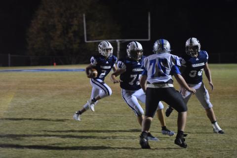 Noah Williams, No, 30, and Dade Anderson, No. 75, clear the way for Tripp Nix on a touchdown run during the second half of the Mountain Athletic Conference championship game Saturday night in Cleveland. (Photos/Mark Turner)