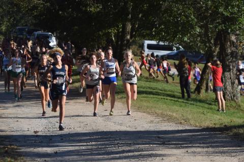 White County's Sydnee Nix, left, and Nealeigh Broadwell, right, keep pace with Oconee County's Molly Meeks during the opening mile of the race. (Photo/Mark Turner)