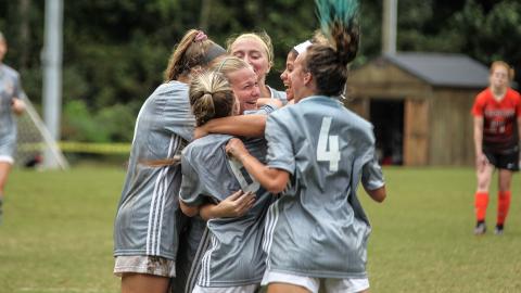 Truett McConnell's Sydney League, center, celebrates with her teammates after scoring the game-winning goal in a 1-0 victory over Union College.  (Photo/TMU Athletics)