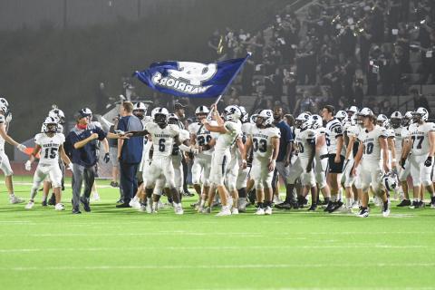 The WCHS players fly the Warrior flag moments after finishing off a 28-21 win over Habersham Central. (Photos/Tom Askew)
