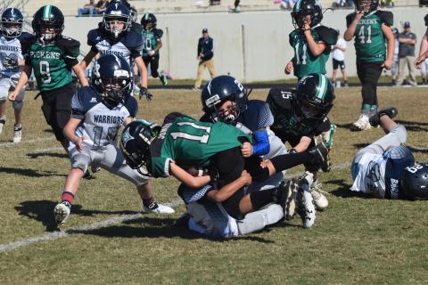 Ryder Rewis of the 8U team makes a tackle during the winning effort. (Photo/Mark Turner)