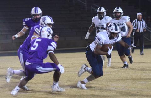 WCHS receiver Daruis Cannon, right, runs away from a pair of Cherokee Bluff defenders during the first quarter of the region game. Cannon had three first half touchdoown catches to help the Warriors grab a 34-7 lead.