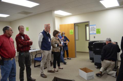 Election Superintendent Garrison Baker shows the newly formed White County Board of Elections how to retrieve the paper ballots from the machines at the voter registrar office. He also explained the process of what to do with the ballots after they are collected. (Photo/Stephanie Hill)