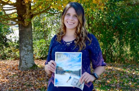Heather Conner of Clayton holds a copy of her photograph of a water skier, which graces the cover of the winter 2020 edition of Lake Living magazine. In addition to having her photograph on the magazine’s cover, Conner won $100. (Photo/Kimberly Brown)