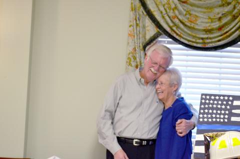 Sheriff Neal Walden hugs his wife, Pam. He thanked family for their support during his career.