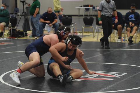 Devin Sullens, left, needed less than two minutes to win two matches and earn the 220-pound title at the Holiday Clash. (Photos/Mark Turner) 