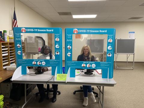 om left, poll workers Annie Sutton and Debora Palmer are all smiles as they help residents who are early voting at the voter registrar office. (Photo/Stephanie Hill)