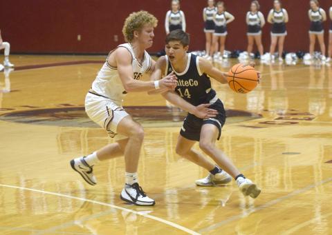 Jadon Yeh, right, shown working against Dawson County's Jaden Gibson, had a three-point play in the final 30 seconds of the game to lift the Warriors to a 59-58 win. (Photo/Mark Turner)