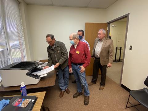 A demonstration of how ballots were scanned during the most recent recount was given Monday, Nov. 30. Shown from left are Board of Elections member Dwayne Turner, poll worker John Connell, County Chairman Travis Turner and County Elections Superintendent Garrison Baker. There were no changes to the White County results during the second recount completed last week. (Photo/Stephanie Hill)