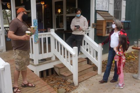 Anna Robertson Bennett and her daughter, Isabel, (right) discuss the upcoming voter registration drive with Sautee resident Dustin Reed (left) and Sweetwater employee River Fox Nickelson (center). (Submitted photo)