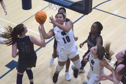 Dasha Cannon puts up a shot in between several West Hall defenders during the region game Tuesday night in Cleveland. (Photo/Mark Turner)