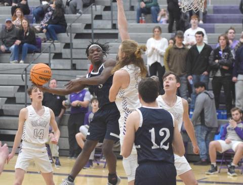 Silas Mulligan dumps off a pass to Jimmy King, No. 12, during the Warriors' win Tuesday night over Gilmer County. (Photos/Mark Turner)
