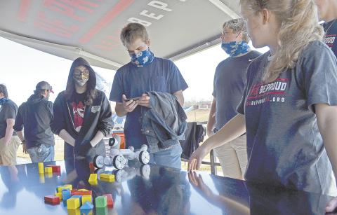  Casen McGuire tries his hand at the robotics station. (Photo/Stephanie Hill)