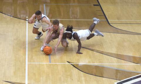 White County's Reece Dockery, left, and Silas Mulligan, and Dawson County's Jadon Gibson dive for a loose ball during the region title game Tuesday in Ellijay. (Photo/Mark Turner)