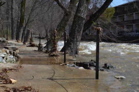 Even though it had gone down by Friday morning, the Chattahoochee River was still high and flowing onto the sidewalk in front of the Troll Tavern. (Photo/Stephanie Hill)