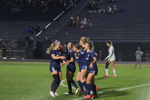 Madison Hunter, left, Leah Alexander, Ada Smith, LaRue Campbell, and Aubrey Dowdy share a hug after the 10-0 win over East Jackson. (Photos/Mark Turner)