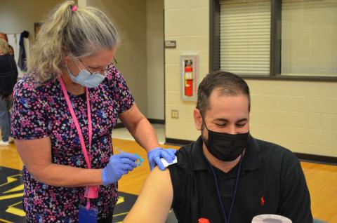 White County Middle School teacher Jack Fullerton waits as WCMS nurse Nancy Mixon administers a COVID-19 vaccine at the White County School System vaccine clinic March 11. (Photo/Stephanie Hill)