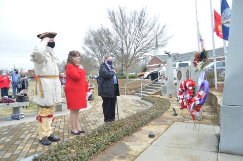 White County’s fallen military service members were honored with a wreath placed at a memorial in Freedom Park during the program. Shown from left are Ed Hendricks, color guard member for the Joseph Habersham Chapter of the Sons of the American Revolution, Cindy Grace, regent for the Tomochichi Chapter of the Daughters of the American Revolution, and Gary Hoyt, veterans committee chairman for the Georgia Society, Sons of the American Revolution. (Photo/Wayne Hardy)