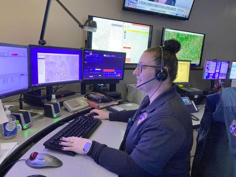 Kimberly Tallman demonstrates what dispatchers do when a call comes in. (Photo/Stephanie Hill)