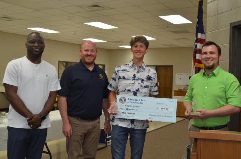 Dr. Octavius Mulligan and Kiwanis President Jason Hogan present plaques to STAR student Charles Causey and STAR teacher Kalin Kennedy. Causey was also presented with a $500 scholarship. Pictured from left, Mulligan, Hogan, Causey and Kennedy. (Photo/Stephanie Hill)