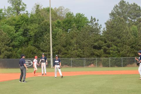 White County's Bailee Patterson, middle, and J. Ben Haynes, right, celebrate after turning a double play to end Game 1 of the Class AAA state baseball series last week in Sonoraville. (Photo/Mark Turner)