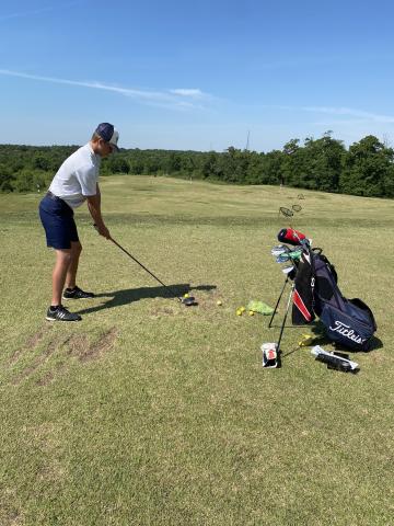 Jacob Adams gets in some work at the driving range  Monday morning before the start of the Class AAA state tournament in Hartwell. (Photo/WCHS Athletics)