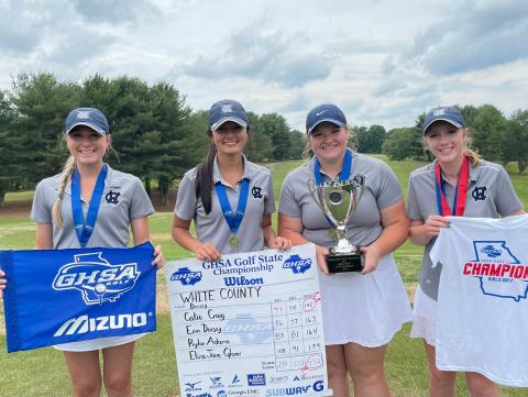 WCHS golfers, from left, Catie Craig, Eliza Jane Glover, Erin Dorsey, and Rylee Adams show off the Class AAA championship trophy Tuesday after winning the school's first ever spring sports team title. (Photo/WCHS Athletics)