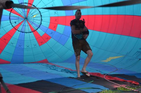 The 48th annual Helen to the Atlantic Balloon Race and Festival wowed the crowds during the showcase, held June 3-5. Pilot Jonathan Wright is shown inside a balloon during inflations last Thursday, holding his dog, Wicket. (Photo/Wayne Hardy)