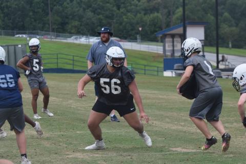 Offensive tackle JD Trowell, an All-Region pick last season, works during a team drill Tuesday at the Warriors' second acclimation practice session. (Photo/Mark Turner)
