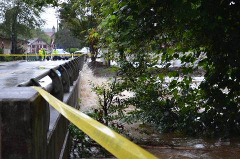 The bridge by the Helen Festhalle on Edelweiss Strasse was closed due to flooding from the river. Pictured above is water hitting the bridge and splashing onto the road. (Photo/Stephanie Hill)