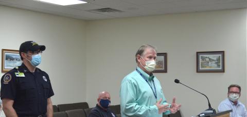 Northeast Georgia Medical Center Director of Emergency Medical Transportation Scott Masters (right) speaks to county commissioners Aug. 30, along with White County Public Safety Director David Murphy (middle) and county EMS Director Bill Scandrett (left). (Photo/Wayne Hardy)