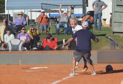 Katelyn Boman celebrates with WCHS head coach Drew Owens moments after scoring the winning run in a 4-3 victory over Cherokee Bluff. (Photo/Mark Turner)