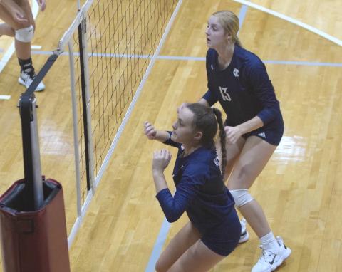 Maggie Blair, left, and Claire Beckman get set to go up for a block during the area win Tuesday night over Dawson County. (Photo/Mark Turner)